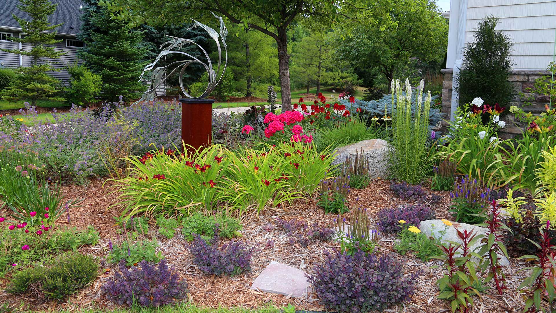 A colorful landscape bed with flowers at an East Lansing home.