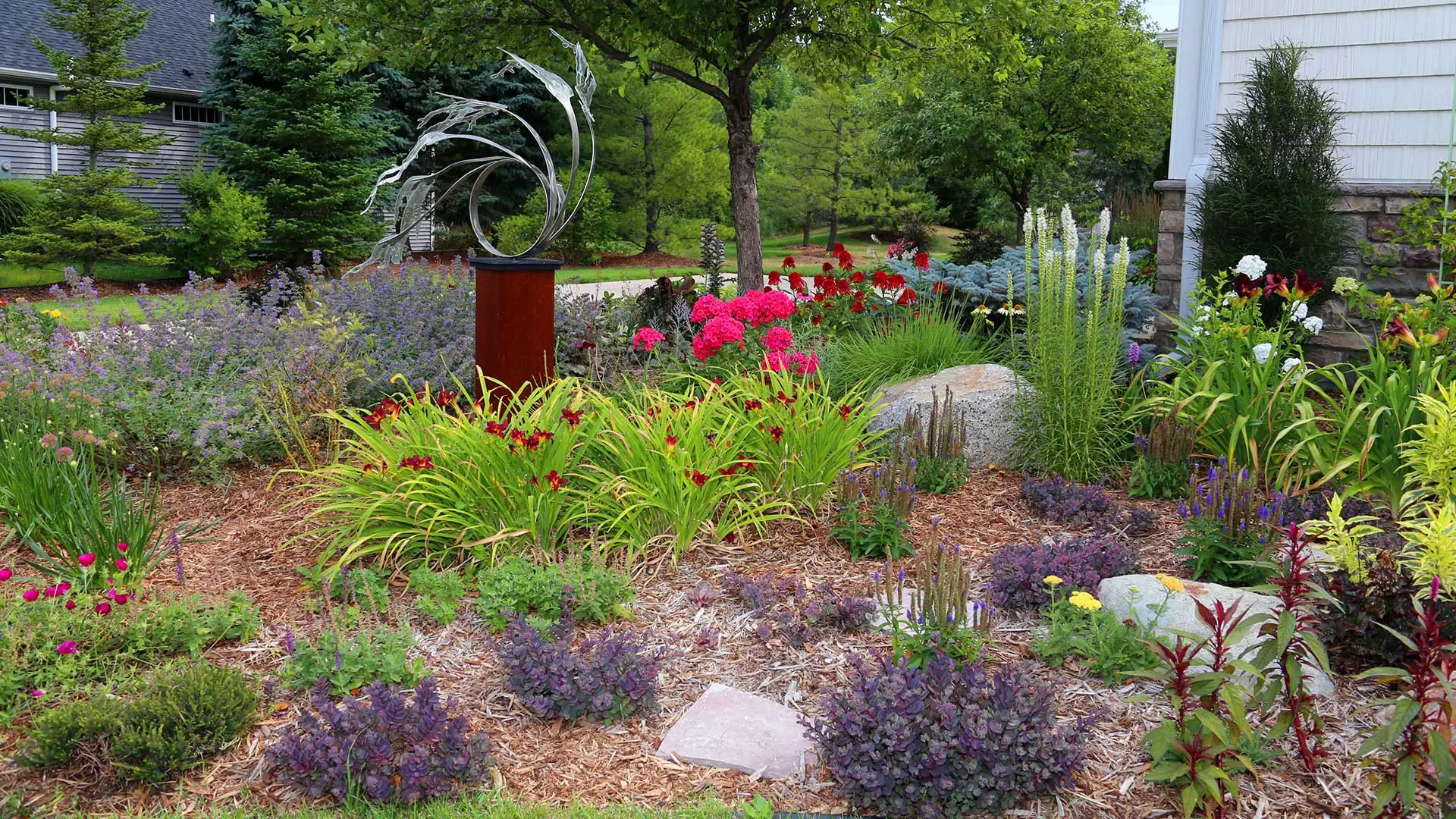 A colorful landscape bed with flowers at an East Lansing home.