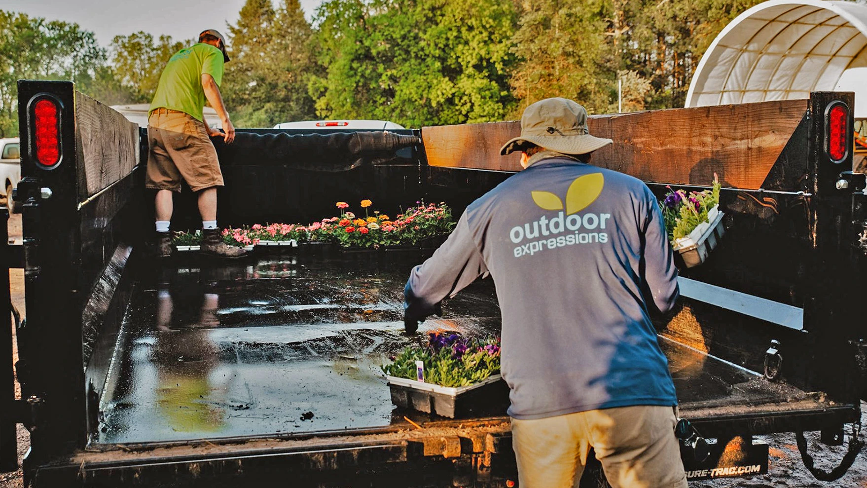 Our landscapers unloading annual flowers off of our truck bed in East Lansing, MI.