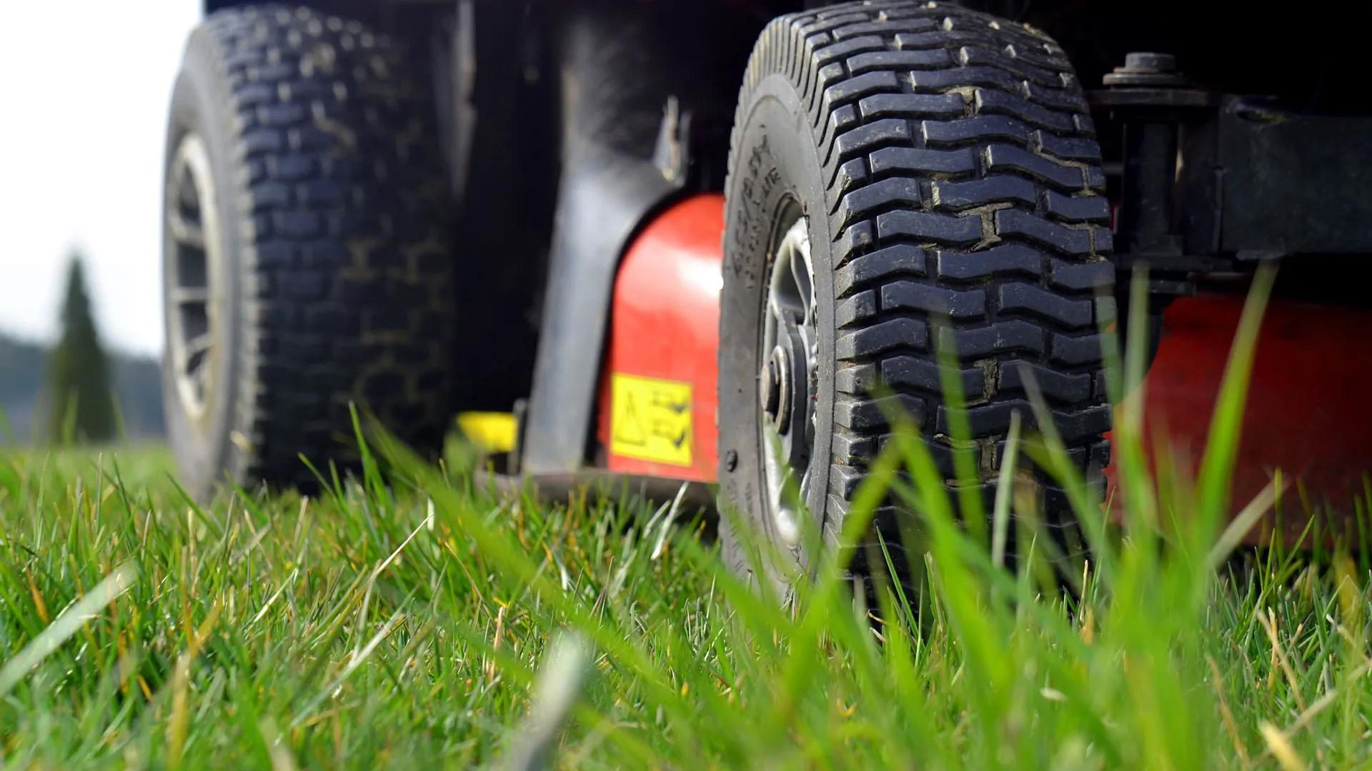 Close up of a lawnmower's tires in grass in Dewitt, MI.