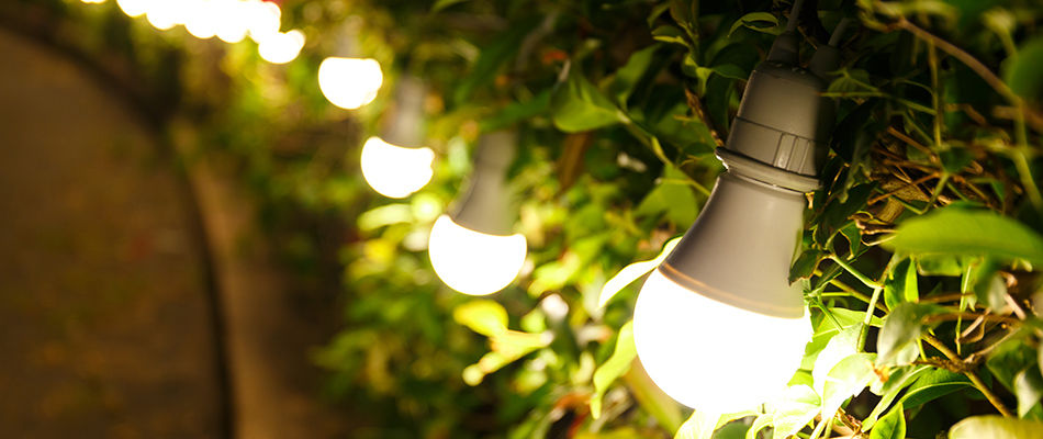 Outdoor lighting is enhancing an outdoor living area at night.