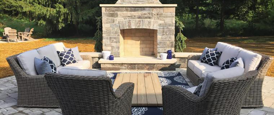 A beautiful outdoor fireplace with great seating around it.