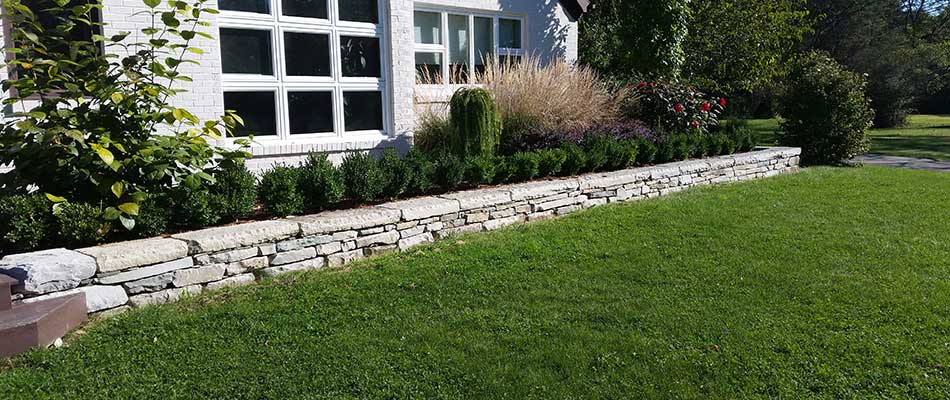 Stone retaining wall installed at a home in East Lansing, MI.